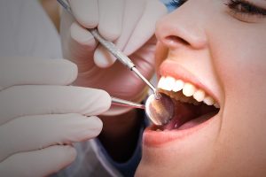 Beautiful female patient visiting dentist for dental checkup