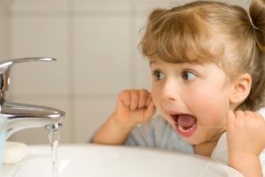 Little girl flossing