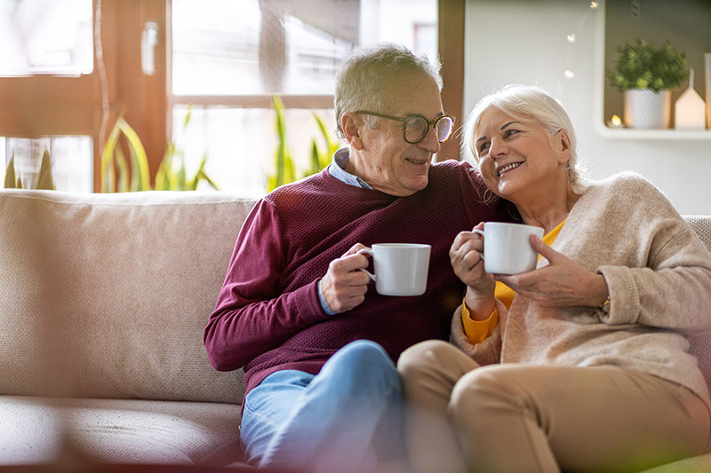 Elderly couple on couch with coffee